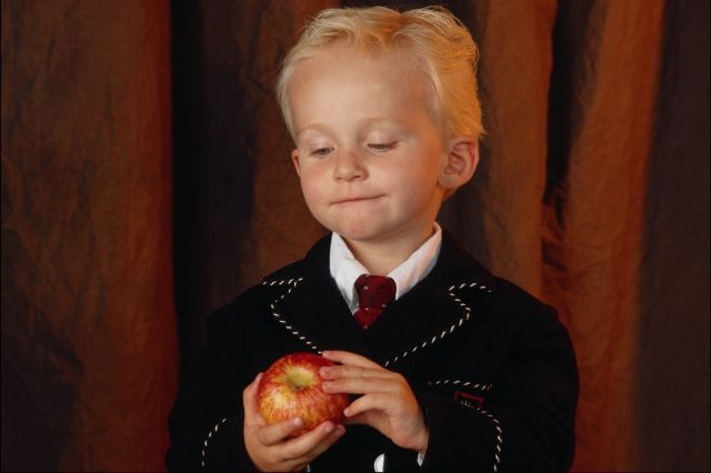 boy contemplating an apple