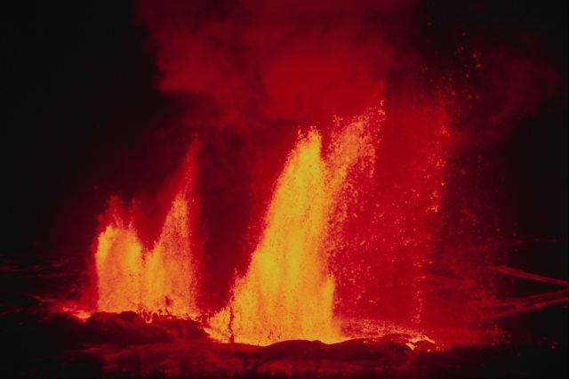 volcano erupting at night